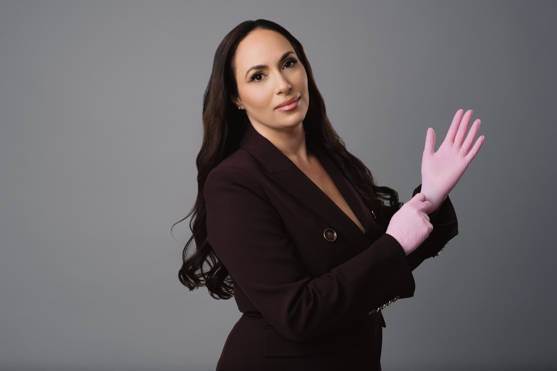 Dr. Tali Arviv, MD putting on clinical gloves